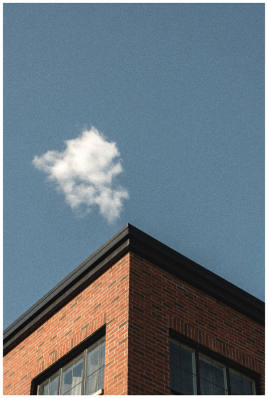 Cloud hovers above a building